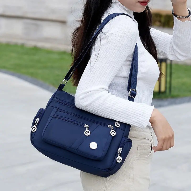 Women nylon waterproof messenger handbag with large capacity, casual design, and shoulder strap, ideal for travel and daily use.
