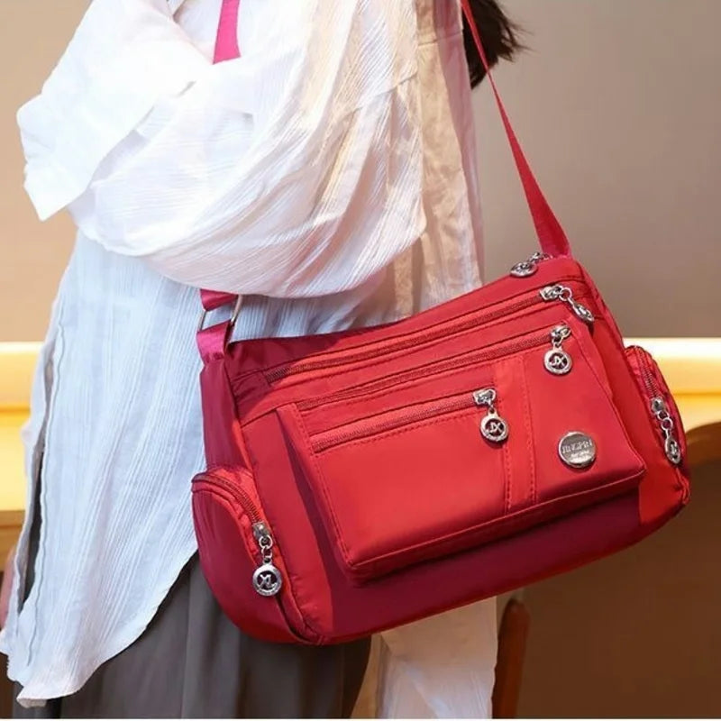 Women’s nylon waterproof messenger handbag with large capacity, casual crossbody style, suitable for travel and everyday use.