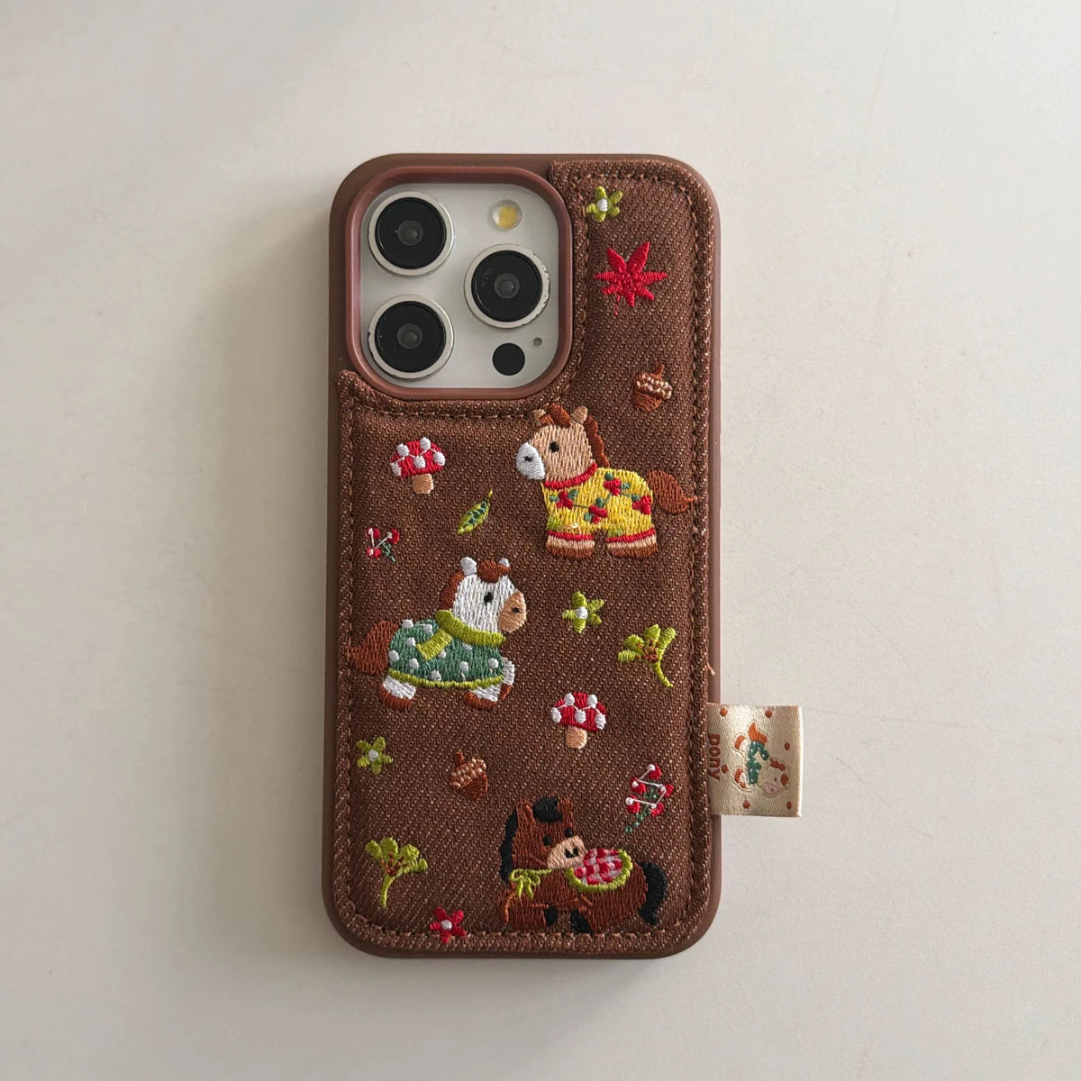 Embroidered Three Ponies phone case for iPhone 17 and 16 Pro by HSF Marketplace