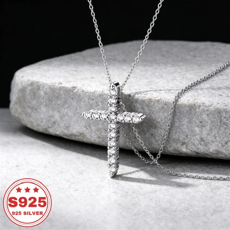 S925 sterling silver cross pendant necklace with cubic zirconia stones on a jewelry display