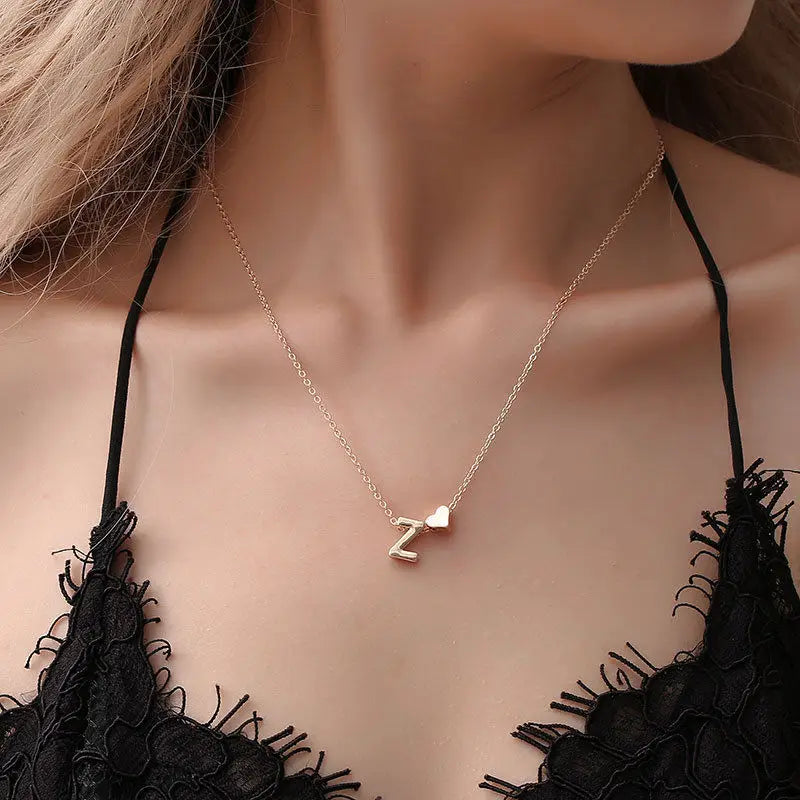 Dainty initial necklace with tiny heart pendant, gold-tone jewelry choker for women, featuring a letter pendant and delicate design.