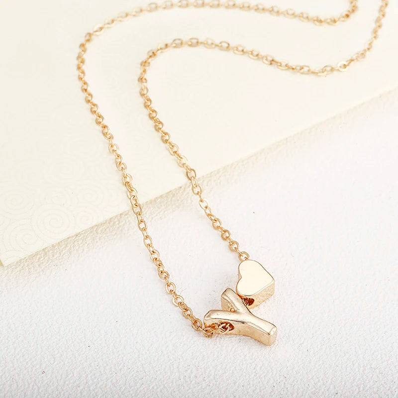 Dainty initial necklace with tiny heart pendant, gold-tone jewelry for women, featuring a letter charm, suitable for gift-giving