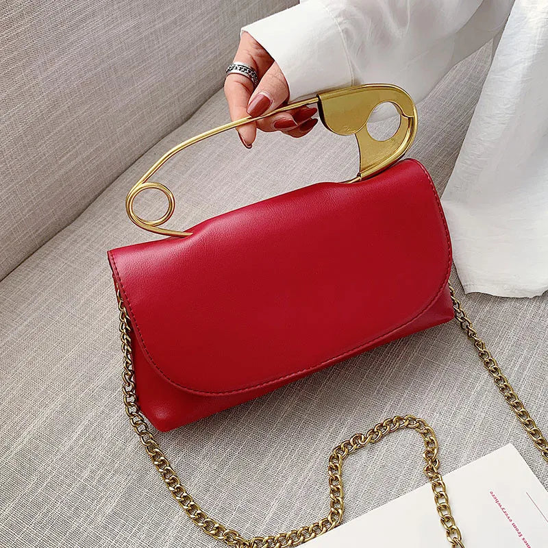 Red retro metal pin design women’s crossbody bag with chain strap, PU leather purse, clutch style handbag, stylish and compact.