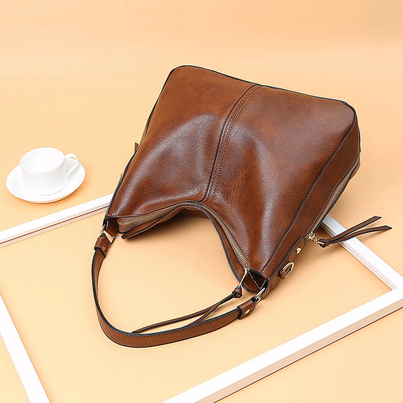 Leather hobo bag for women featuring a spacious tote design, casual shoulder strap, vintage style, and large capacity.