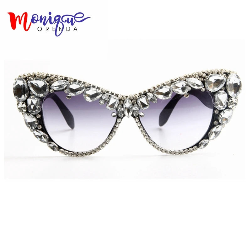Oversized cat eye sunglasses for women with luxury crystal accents and retro style, featuring bold black frames and tinted lenses.