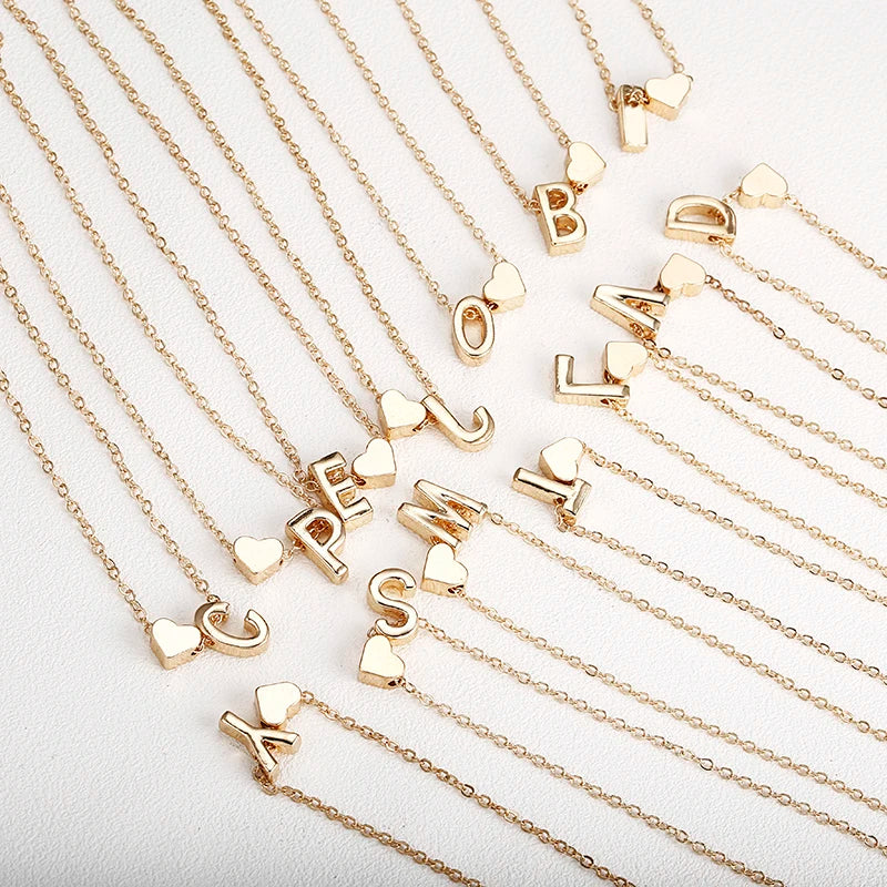 Dainty initial necklace with tiny heart pendant, letter charm, and choker style jewelry for women, featuring a delicate pendant design