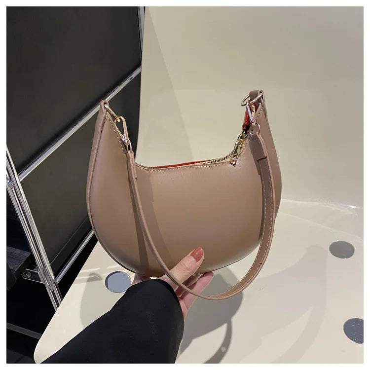 Elegant moon-shaped women's handbag by HSF Marketplace, luxury high-end single shoulder bag with stylish design and premium finish.