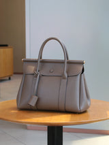 Vintage leather women's handbag with flap closure, soft high-quality leather shoulder bag for office and commute.