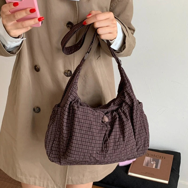 Women’s checkered nylon sling bag with drawstring closure, large capacity trendy crossbody handbag for shopping and casual outings.