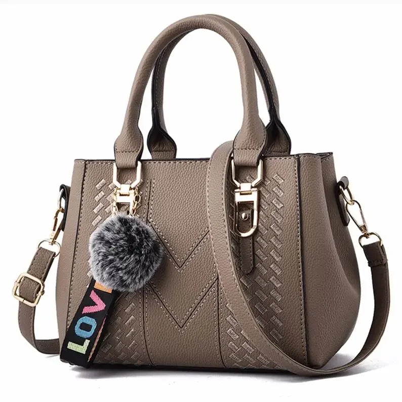 Leather embroidery messenger bag for women, stylish handbag with hair ball detail, versatile purse for daily use.
