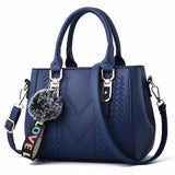 Leather embroidery messenger handbag for women with hairball design, stylish leather purse from HSF Marketplace.