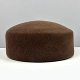 Women's vintage wool felt beret hat with hard concave top, pillbox styling, and fascinator design