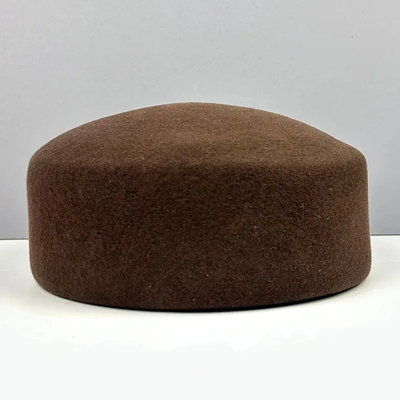 Women's vintage wool felt beret hat with hard concave top, pillbox styling, and fascinator design