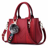 Leather embroidery messenger bag for women with hairball detail, stylish handbag perfect for everyday use.