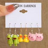 Cute cartoon duck dangle earrings set for girls, featuring playful yellow duck charms in a jewelry design
