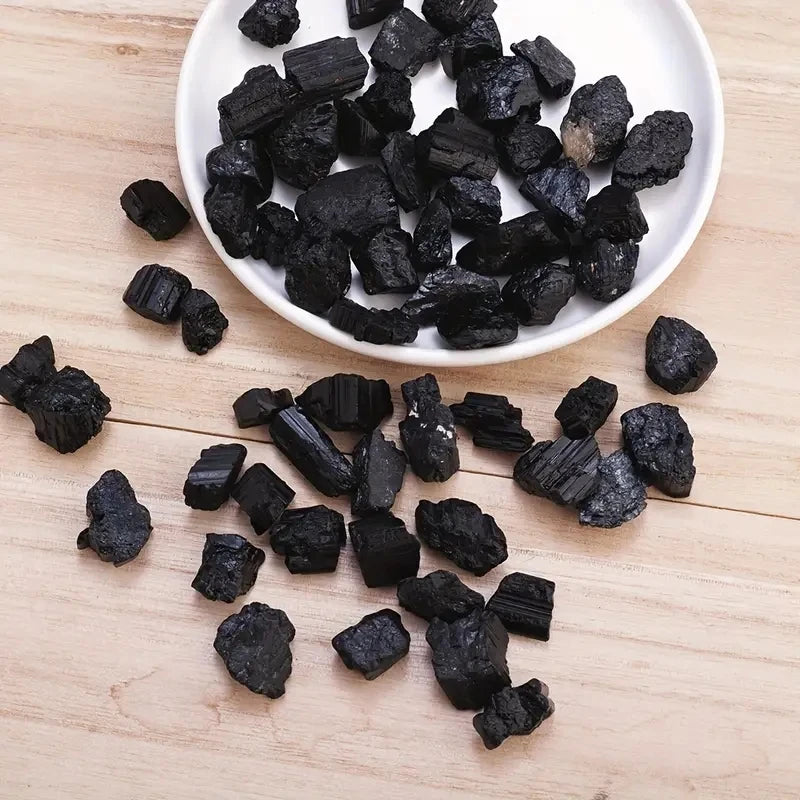 Natural black tourmaline crystal stones, raw irregular mineral specimens in a 100g bag, from HSF Marketplace.