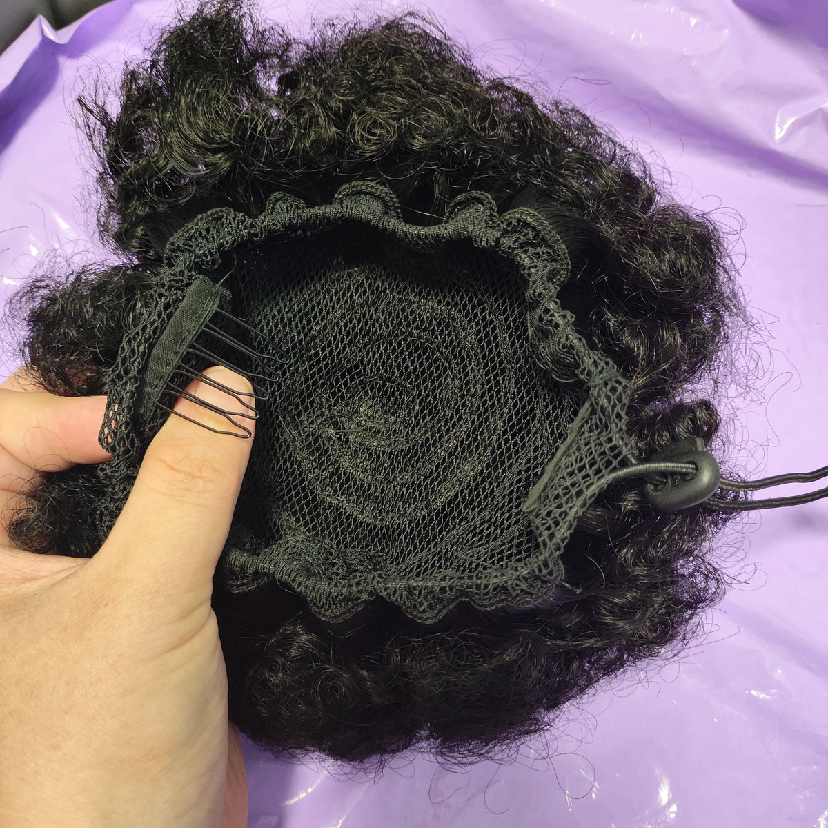 Kinky curly human hair drawstring ponytail bun with Brazilian clip-in extensions in natural curls