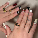 Pink and black Sweet Punk long coffin press-on false nails with French, polka dot, and striped designs