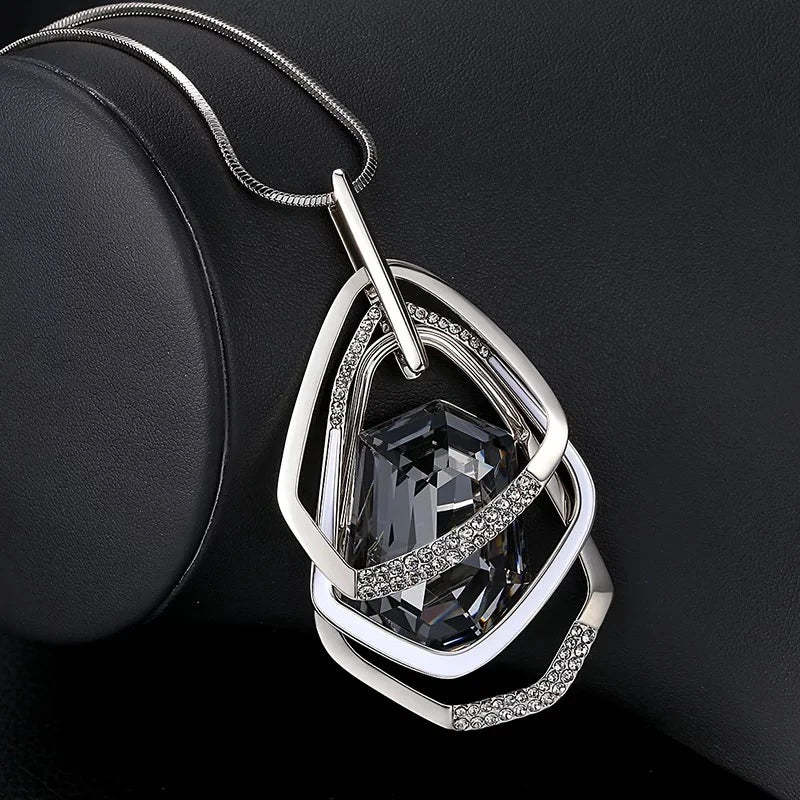 Long geometric pendant necklace for women featuring a stylish chain, fashion jewelry accessory, maxi collar, and statement design.