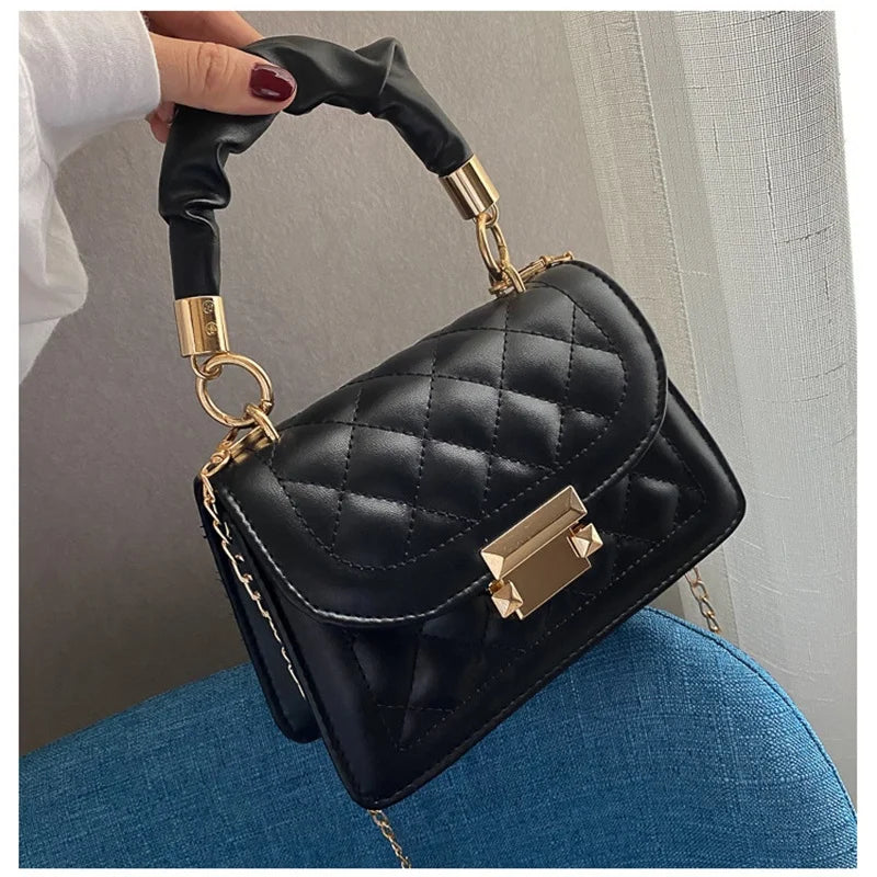 Luxury women's PU leather shoulder handbag with solid color design, small size, and elegant underarm style.