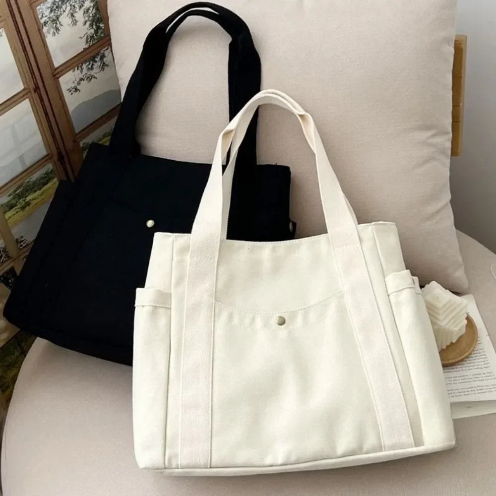 Large capacity canvas tote bag by HSF Marketplace, stylish shoulder bag for work, college, and commuting with ample space for books.