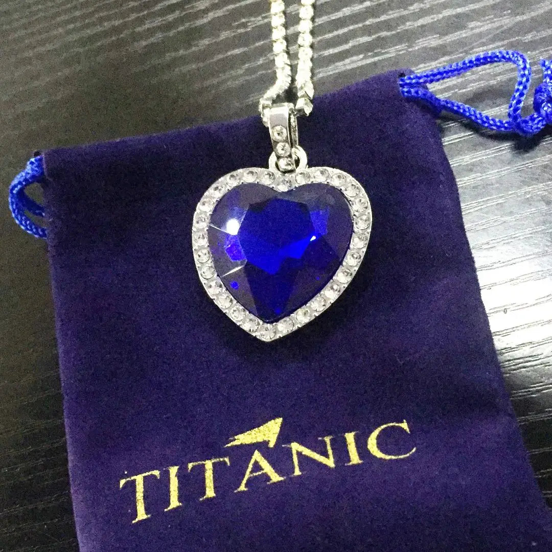 Titanic Heart of Ocean blue heart pendant necklace by HSF Marketplace, displayed with a velvet gift bag.