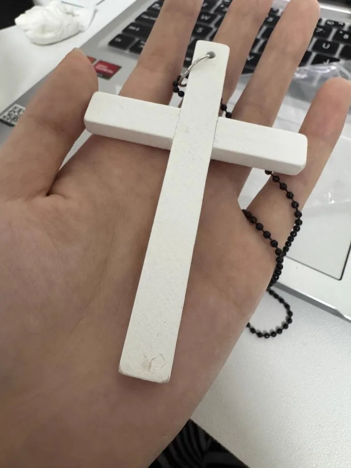 Black and white gothic wood cross pendant necklace with punk and Y2K style, featuring a choker design and sweater chain elements.