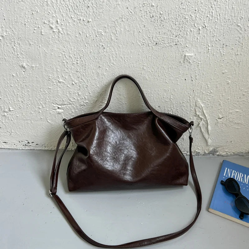 Luxury PU leather women's handbag with spacious design, shoulder and crossbody straps, ideal for commuting and office use.