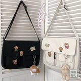 Women’s casual canvas messenger bag with printed design, shoulder strap, and pouch compartment for everyday use.