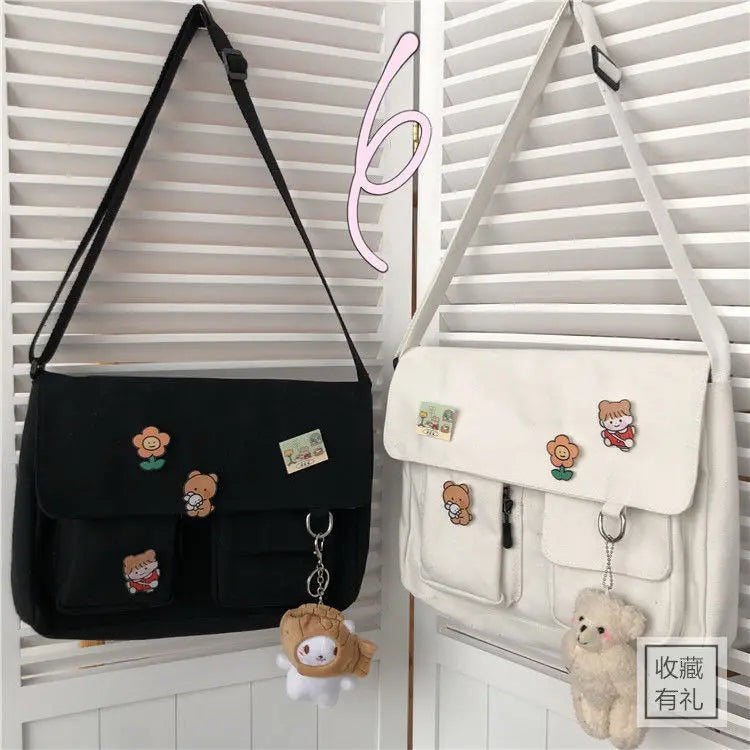 Women’s casual canvas messenger bag with printed design, shoulder strap, and pouch compartment for everyday use.