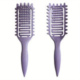 Hollow boar bristle curling and detangling hair styling brush with ergonomic handle for shaping and defining curls.