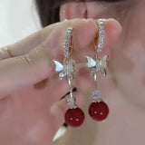 Purple butterfly drop earrings with sparkling rhinestone details by HSF Marketplace