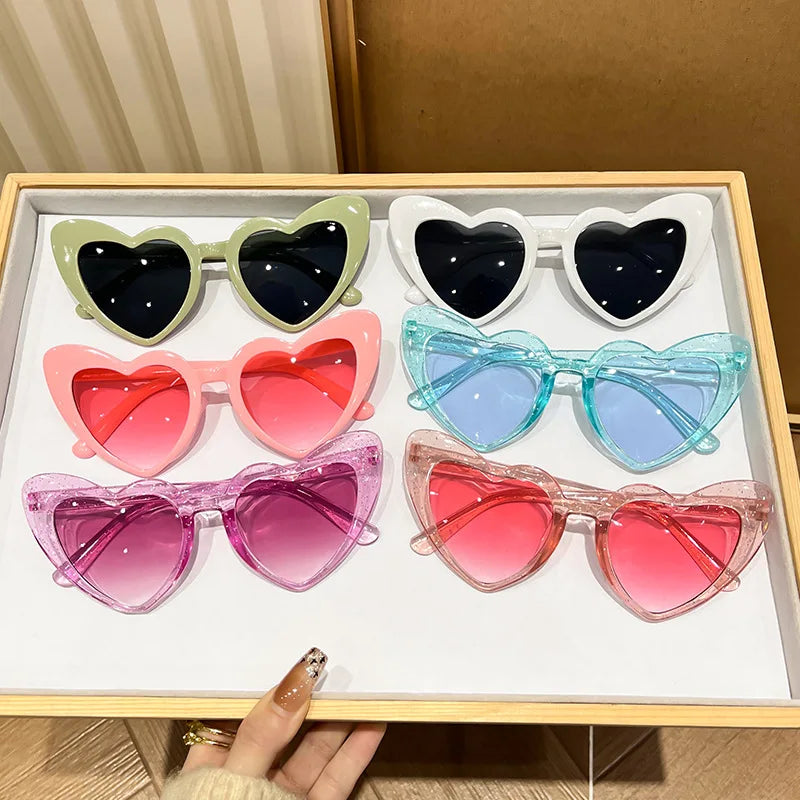 Pink heart-shaped vintage sunglasses for girls, shiny transparent fashion eyewear from HSF Marketplace, perfect for beach parties and photos.