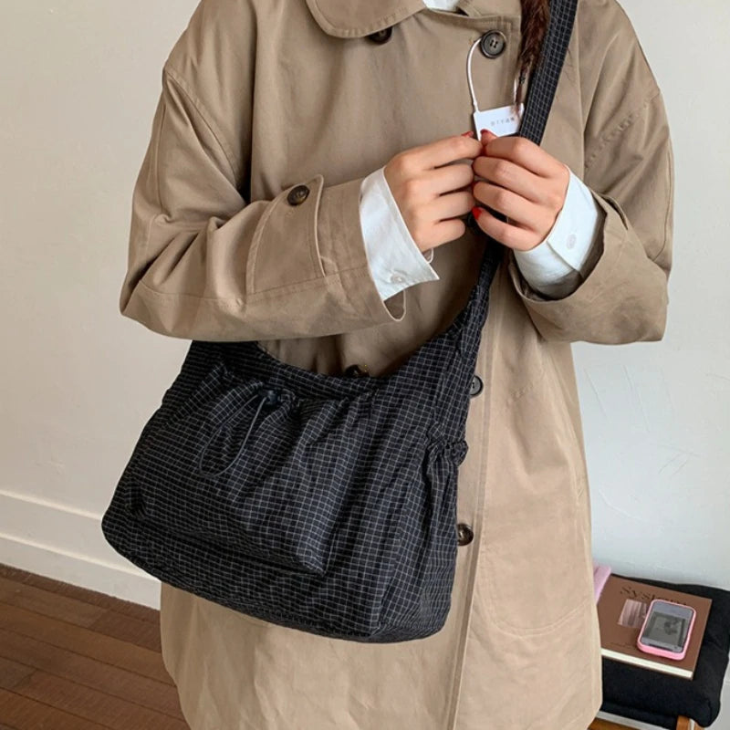 Women’s checkered nylon sling bag with drawstring closure, large capacity trendy crossbody handbag for shopping and casual outings.