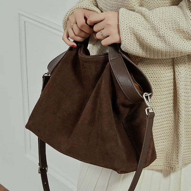 Genuine leather women's handbag with large capacity, shoulder and crossbody styles, featuring cowhide design and spacious tote.