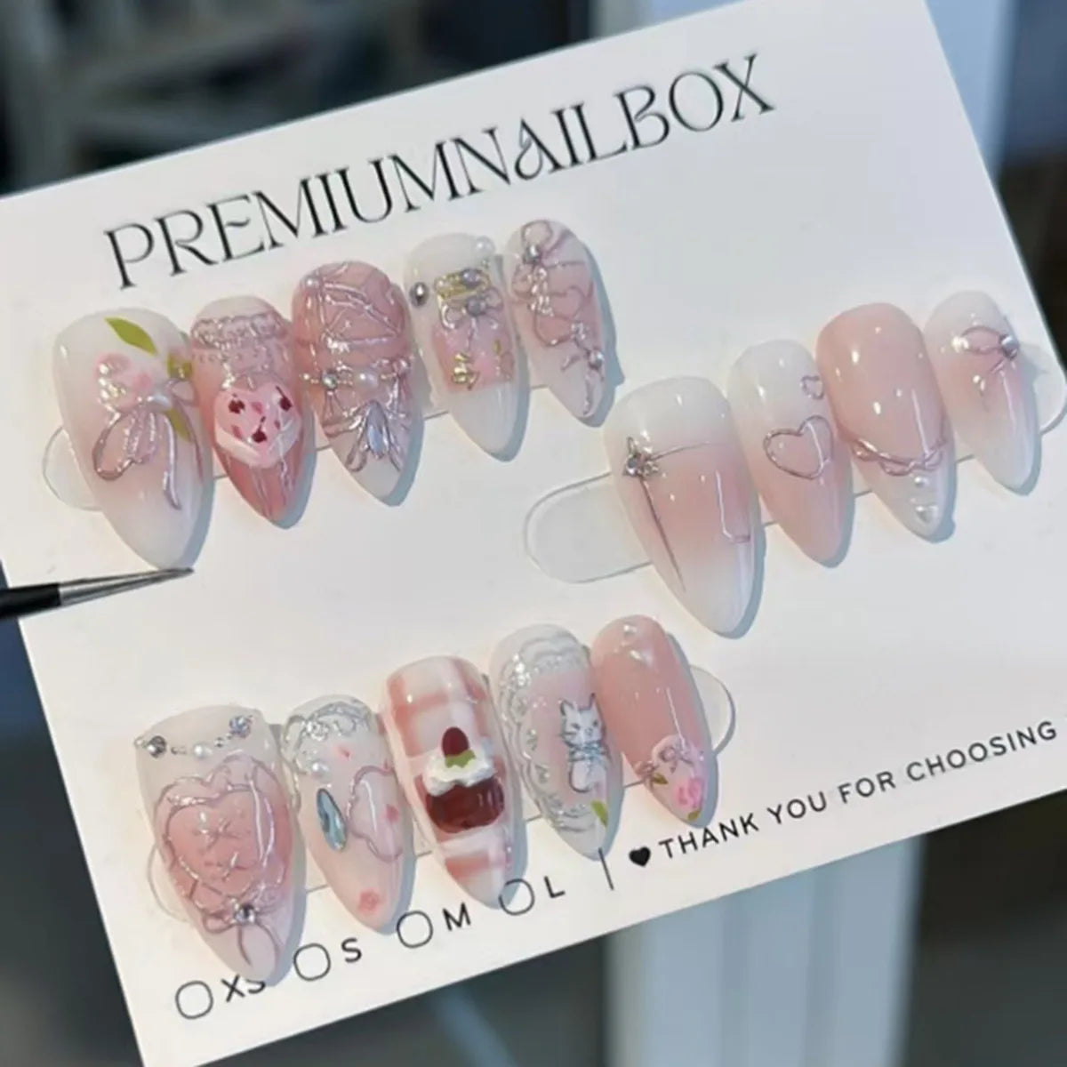 24-piece pink almond false nail tips with bowknot, love heart, and pearl designs by HSF Marketplace