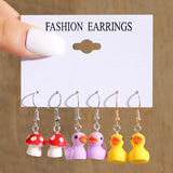 Cute cartoon duck dangle earrings set for girls, featuring playful yellow duck charms and delicate hooks