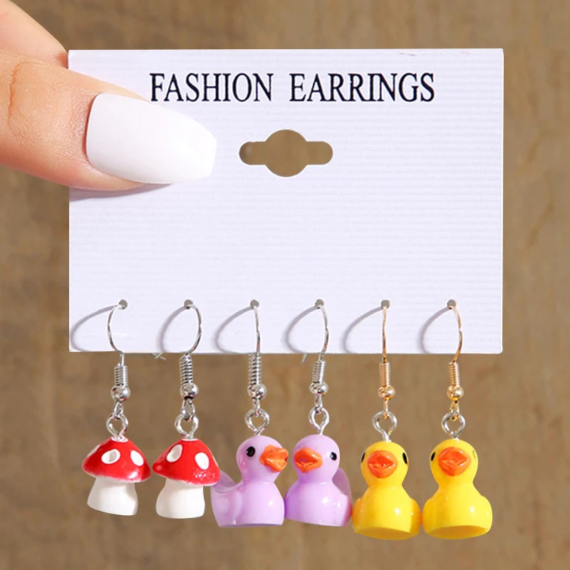 Cute cartoon duck dangle earrings set for girls, featuring playful yellow duck charms and delicate hooks
