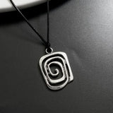 Vintage spiral vortex pendant necklace with hand-woven leather rope, boho goth jewelry for women.