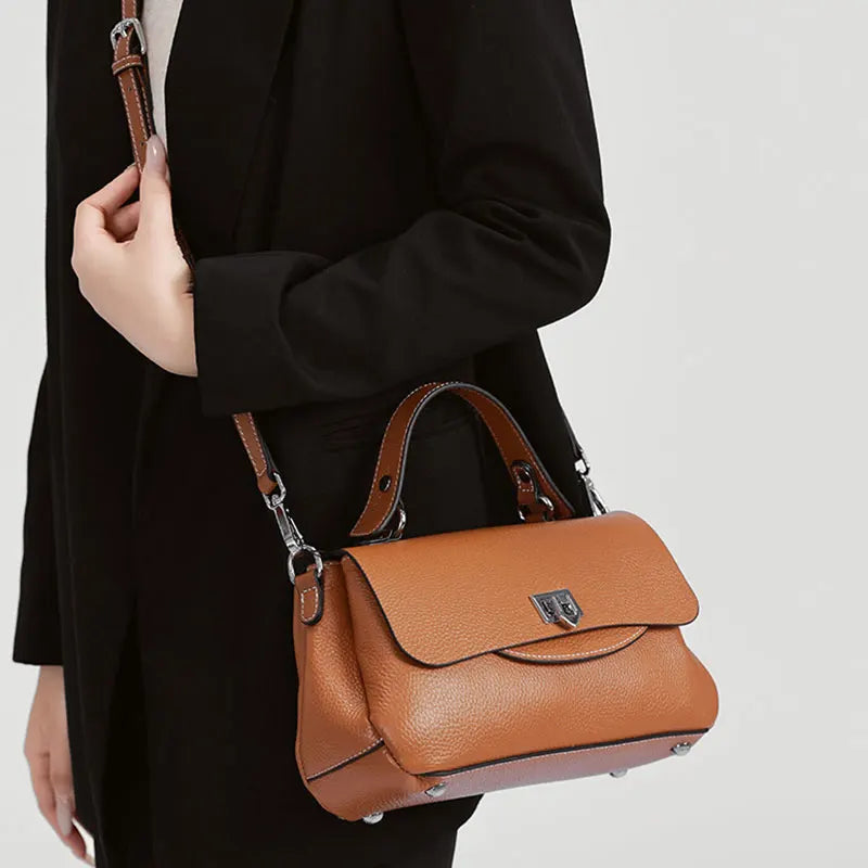 Luxury genuine leather women's crossbody handbag in a structured design with an adjustable shoulder strap