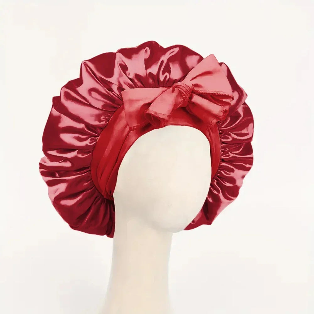 Silk satin sleep bonnet with adjustable tie band for women and men, designed to protect and style hair overnight.