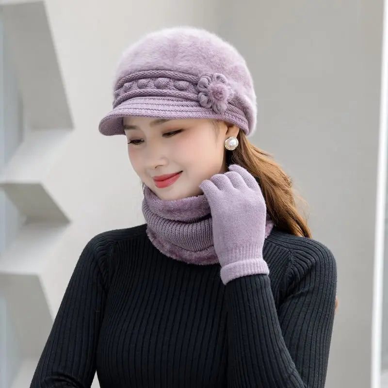 Warm knitted women’s winter hat, scarf, and gloves set in soft coordinating colors.