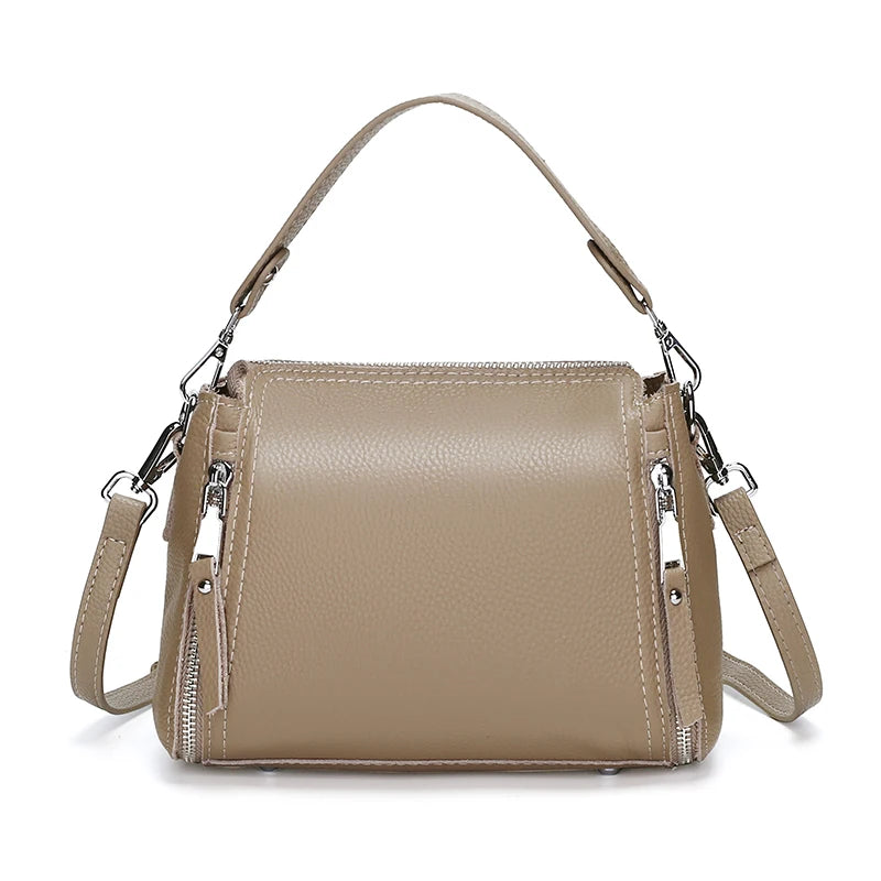 Luxury genuine leather women's messenger handbag with high capacity, crossbody design, cowhide material, and shoulder strap.