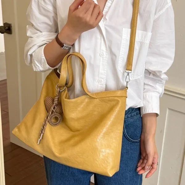 Luxury PU leather women's handbag with spacious interior, designed for shoulder or crossbody wear, ideal for commuting and office use.