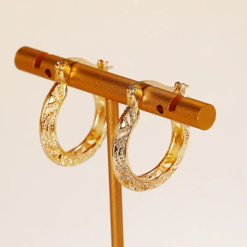 Huitan hollow-out hoop earrings for women in modern metal style, close-up product view