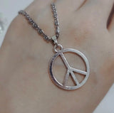 Hippie peace sign necklace in stainless steel for women, featuring a classic peace symbol pendant