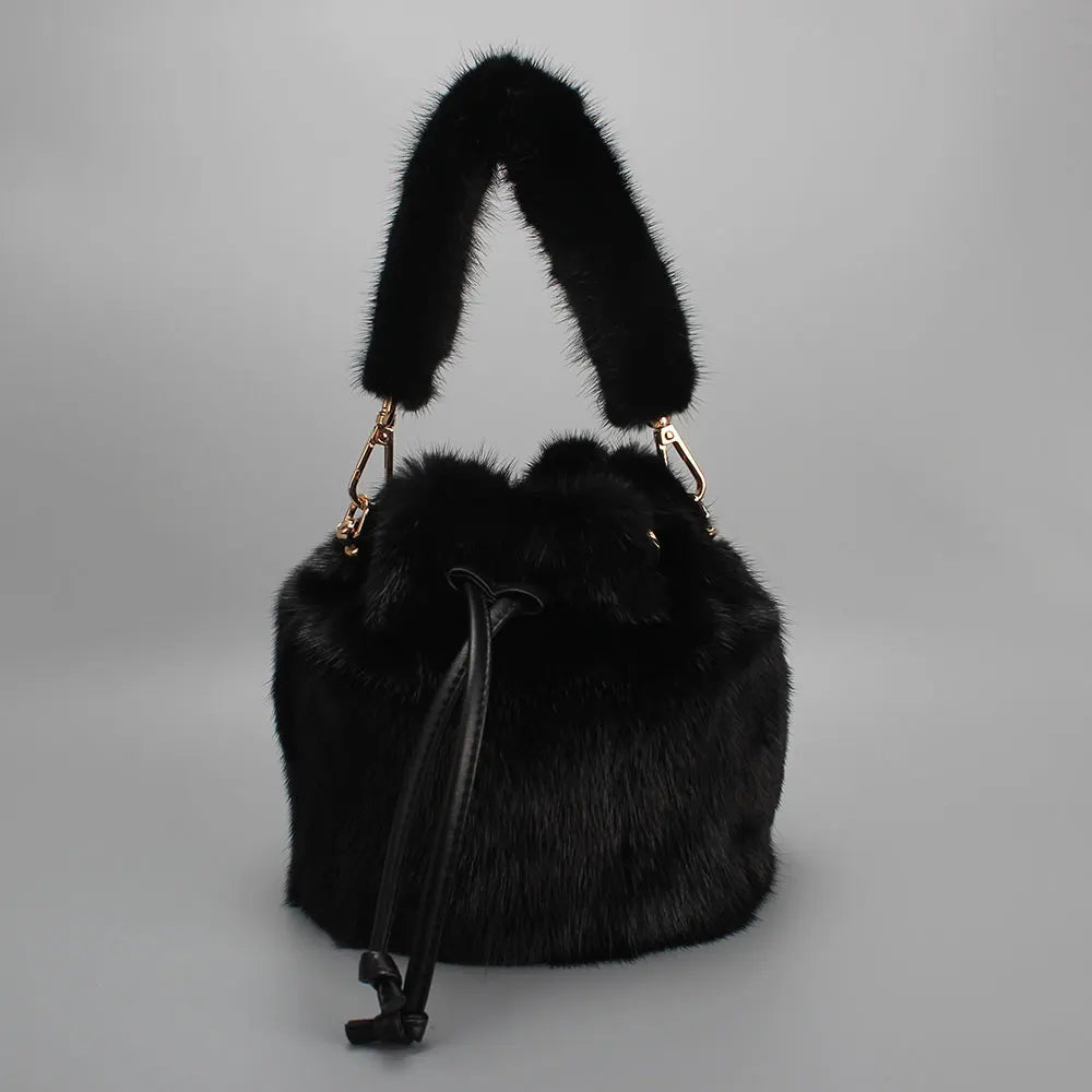Luxurious real mink fur bucket handbag for women, soft fluffy winter crossbody purse with elegant design and gold-tone accents.