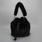 Luxurious real mink fur bucket handbag for women, soft fluffy winter crossbody purse with elegant design and gold-tone accents.