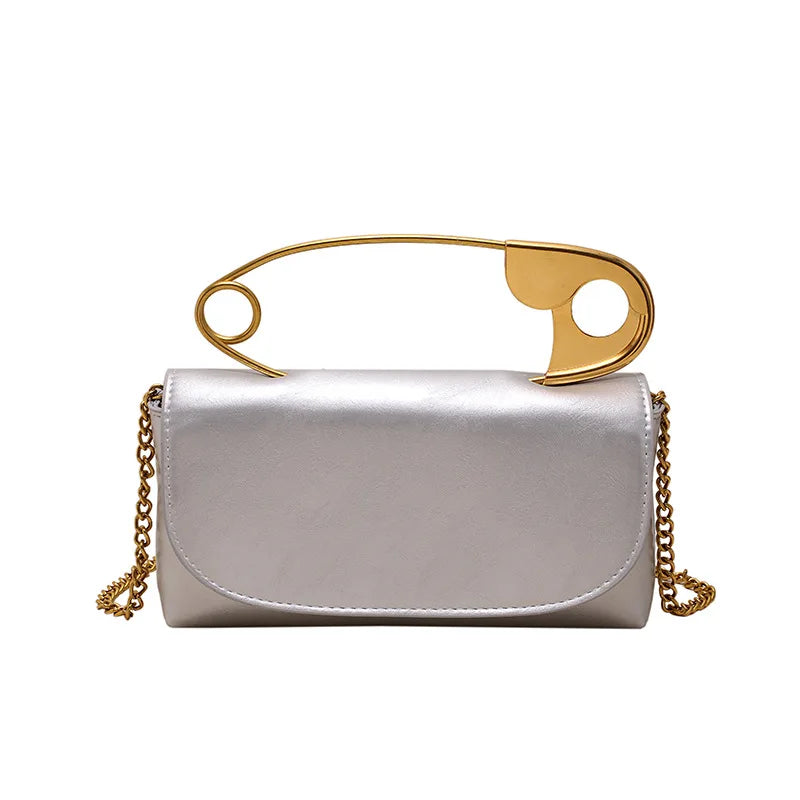 Red retro metal pin design women’s crossbody bag with chain strap, PU leather purse, clutch style handbag, stylish and compact.