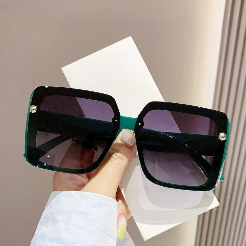 Vintage women's square sunglasses with large frame in retro style, featuring dark shades and bold design from HSF Marketplace.